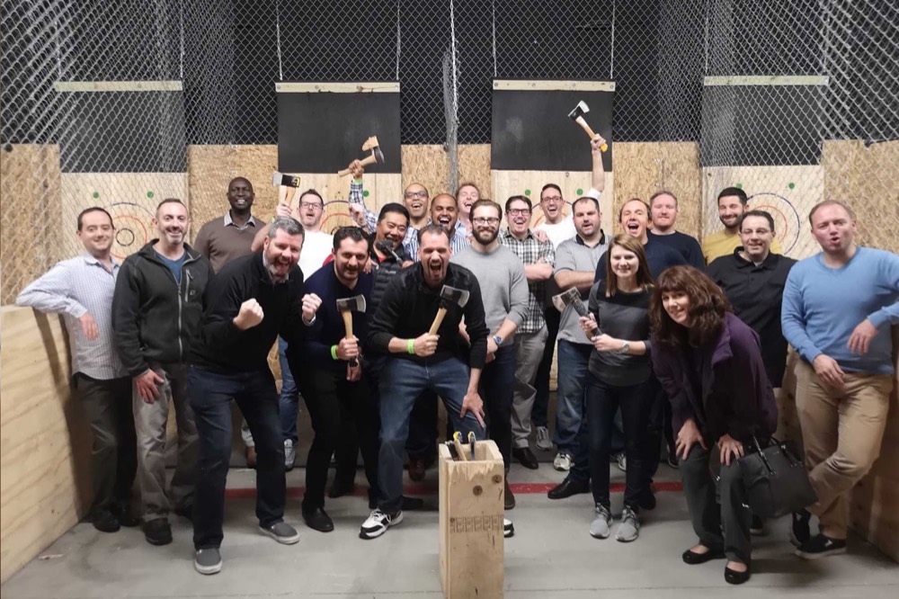 Team participating in axe throwing and casual social competitions